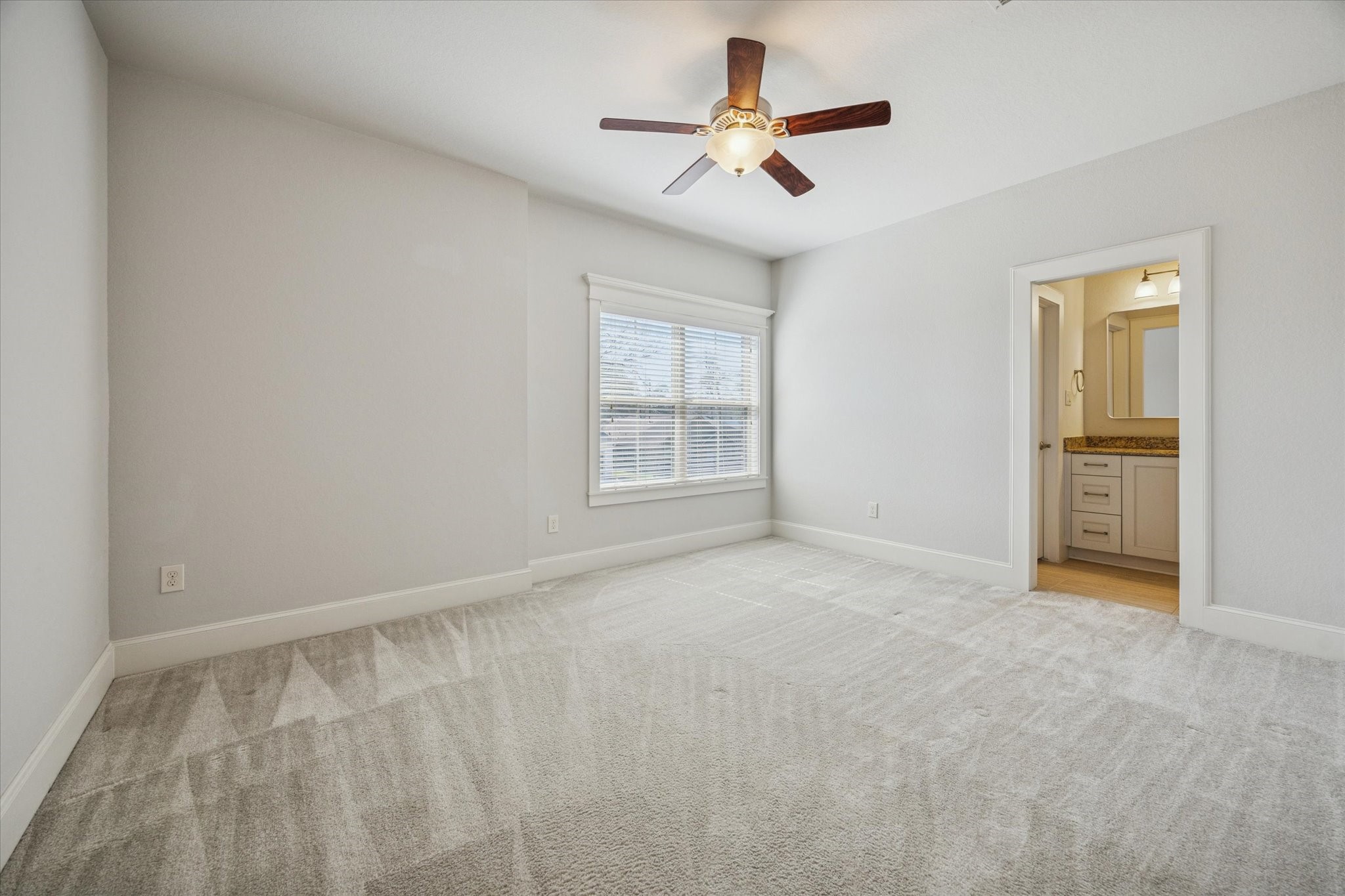 1802 Wakefield Drive Houston, TX 77018 - Photo 33 of 47 Guest room features a large window, ceiling fan with light kit and a neutral color palette with ensuite bathroom.