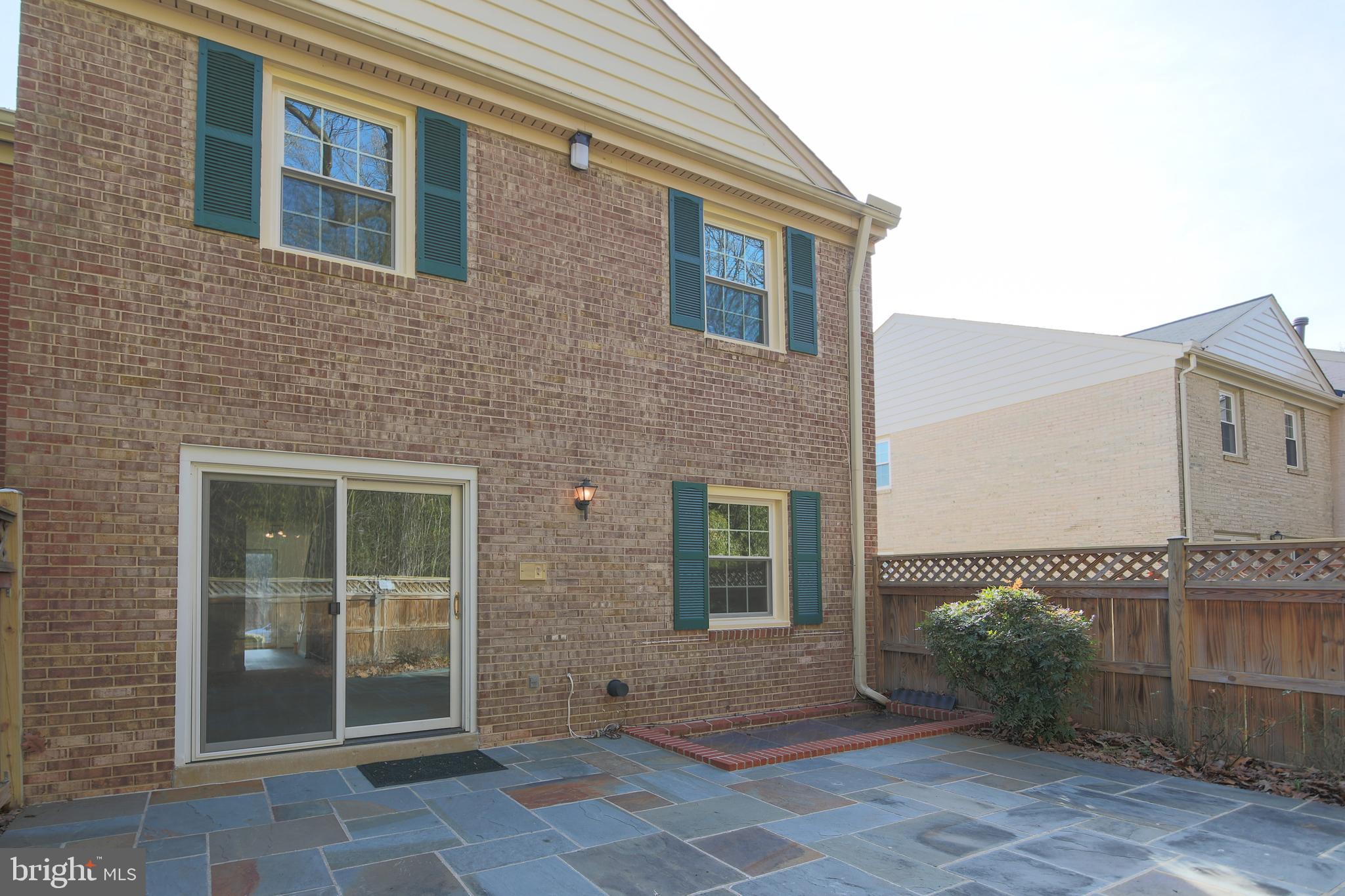 9738 Cardinal Road Fairfax, VA 22030 - Photo 27 of 63 Sliding Doors Lead to Slate-Lined Patio