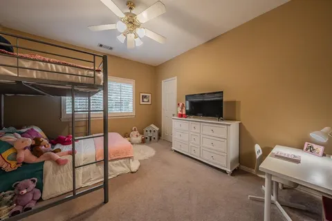 a bedroom with a bed and a tv
