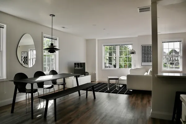 a front view of a house with wooden floor and windows