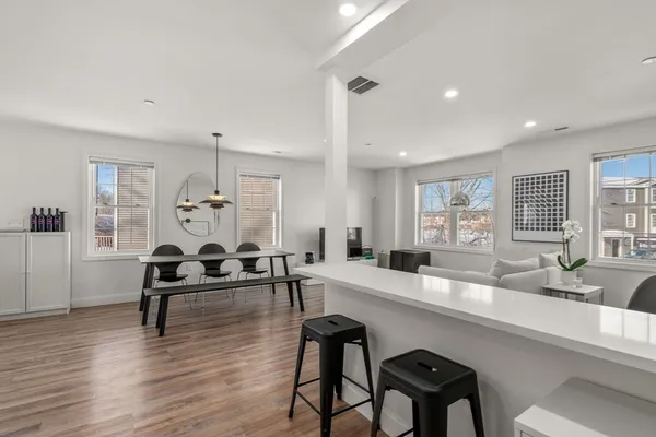 a kitchen with white cabinets and white appliances