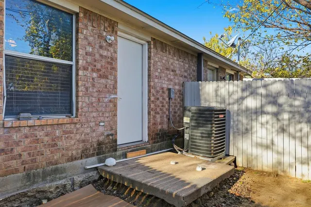 a backyard of a house with table and chairs