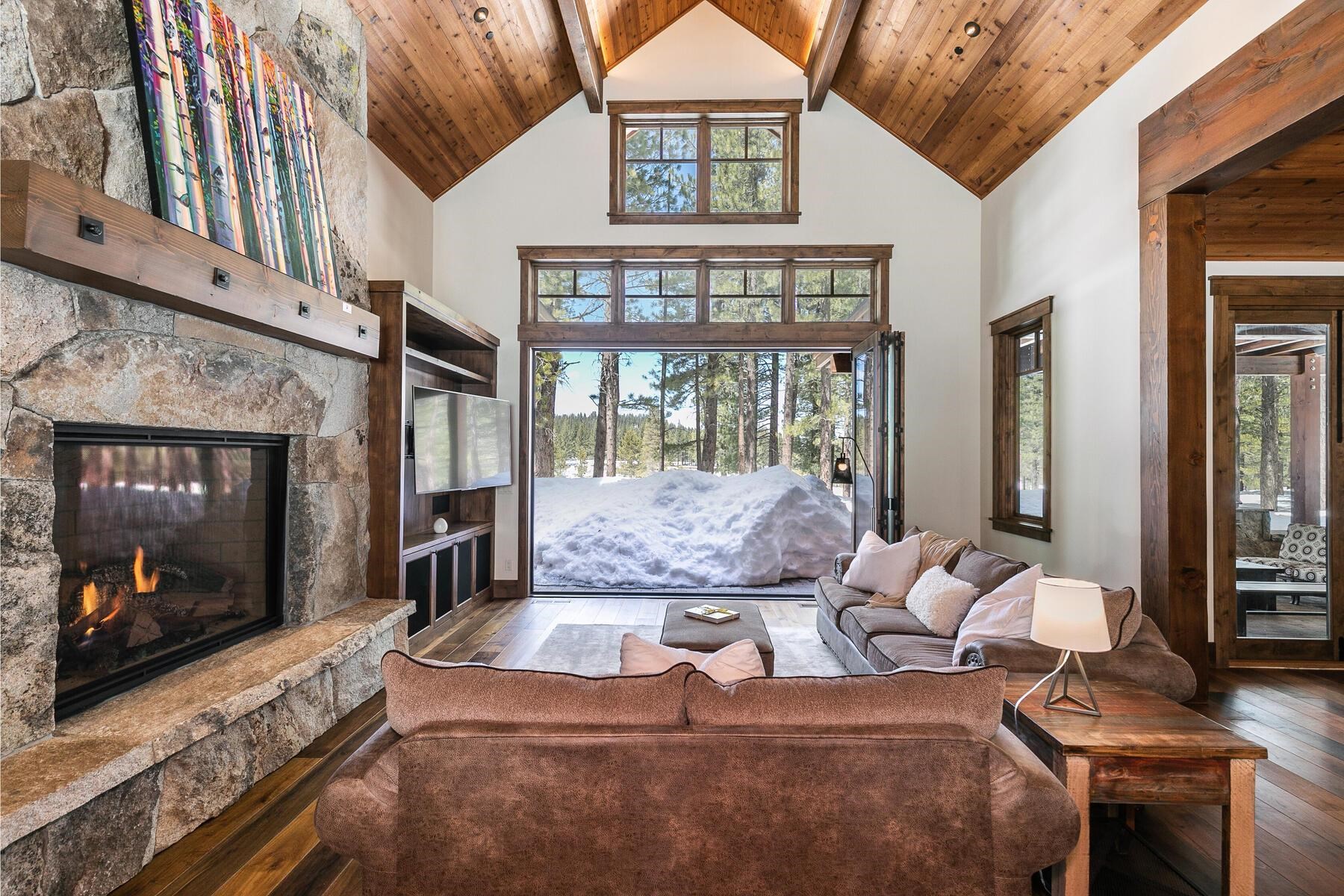 11478 Henness Road Truckee, CA 96161 - Photo 2 of 21 a living room with furniture large window and a fireplace