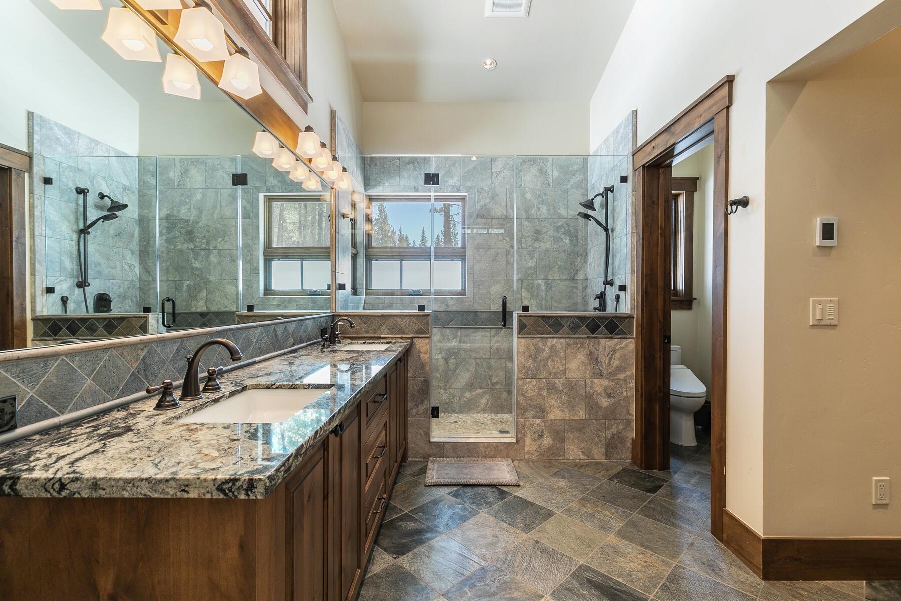 11478 Henness Road Truckee, CA 96161 - Photo 9 of 21 a bathroom with a granite countertop sink a mirror and shower