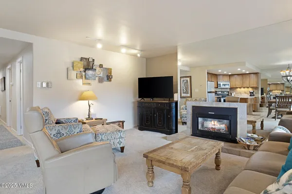 a living room with furniture a fireplace and a flat screen tv
