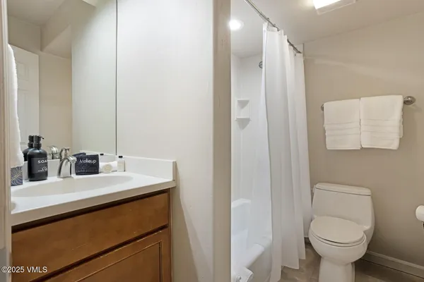 a bathroom with a sink toilet and mirror