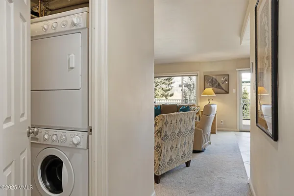 a view of a hallway with furniture and front door