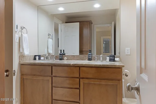 a bathroom with a double vanity sink and a mirror