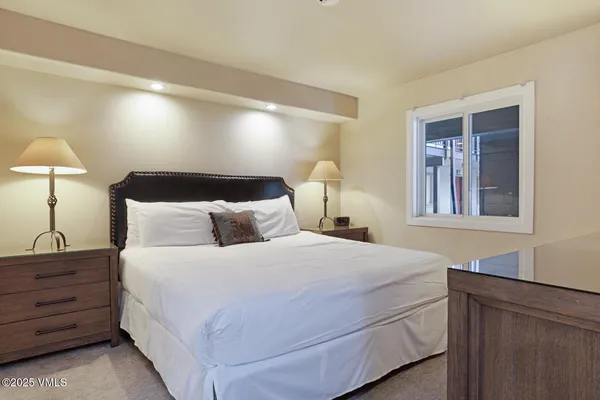 a bedroom with a bed and a lamp