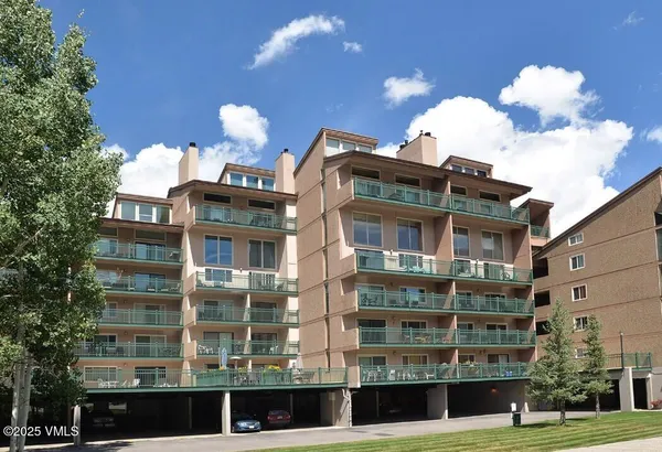 a front view of a building with lot of fountain and entertaining space