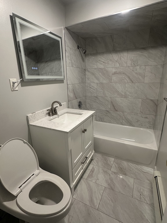 5 Crowell Street, Unit 1 Boston, MA 02124 - Photo 2 of 8 a bathroom with a toilet a sink and mirror