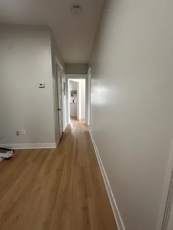 a view of hallway with wooden floor