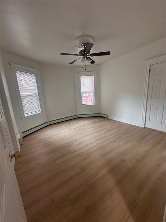 5 Crowell Street, Unit 1 Boston, MA 02124 - Photo 6 of 8 an empty room with windows and fan