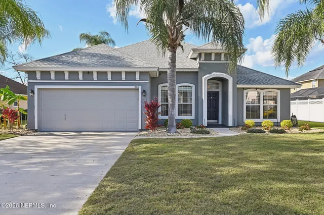 a front view of a house with garden and porch