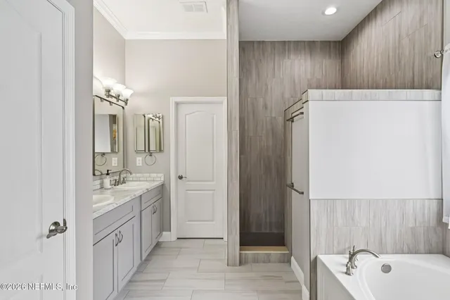a bathroom with a tub and shower
