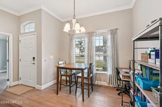 a view of a dining room with furniture window and wooden floor