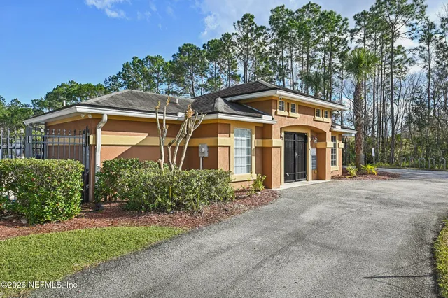 a view of a backyard with table and chairs under an umbrella