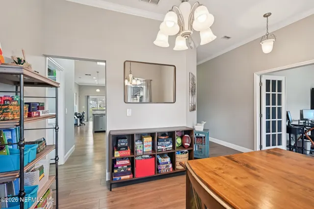 a bedroom with furniture and a chandelier