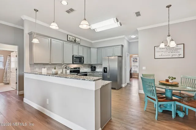 a kitchen with stainless steel appliances granite countertop a sink and stove top oven