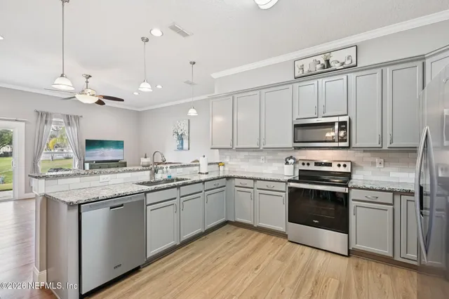 a kitchen with cabinets stainless steel appliances and a counter space