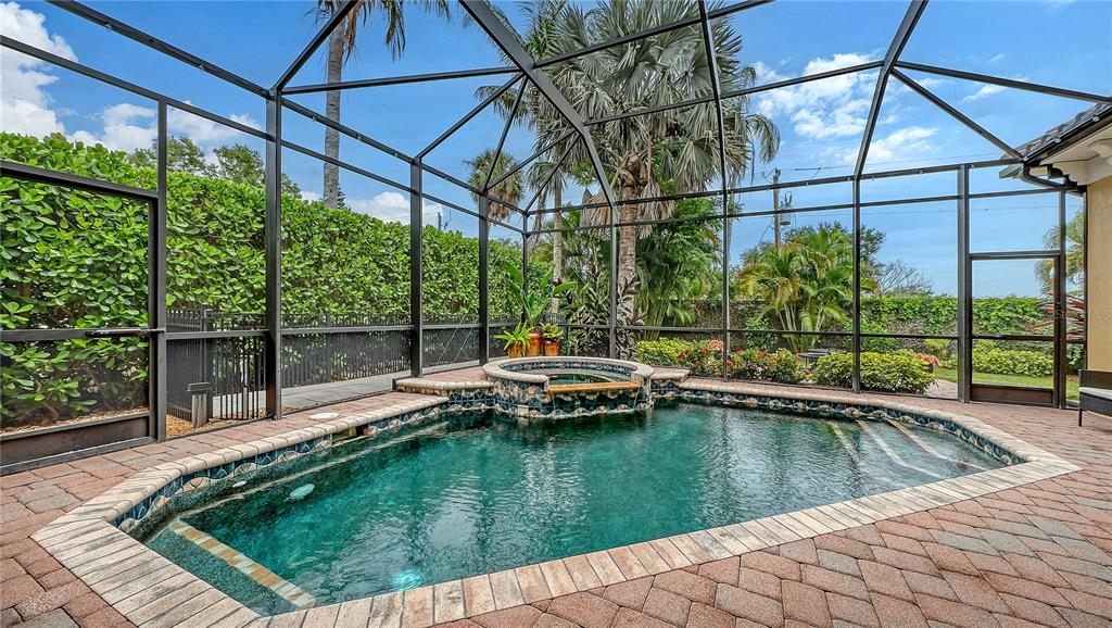 1630 Assisi Drive, Unit 18 Sarasota, FL 34231 - Photo 30 of 42 a view of a swimming pool with a patio