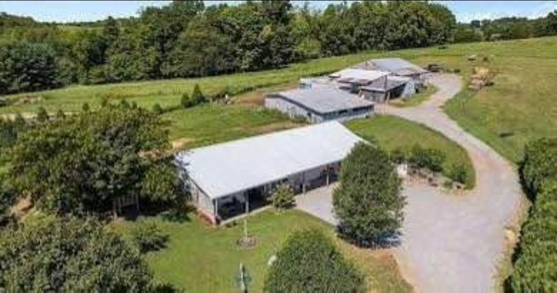 an aerial view of a house with a yard and lake view