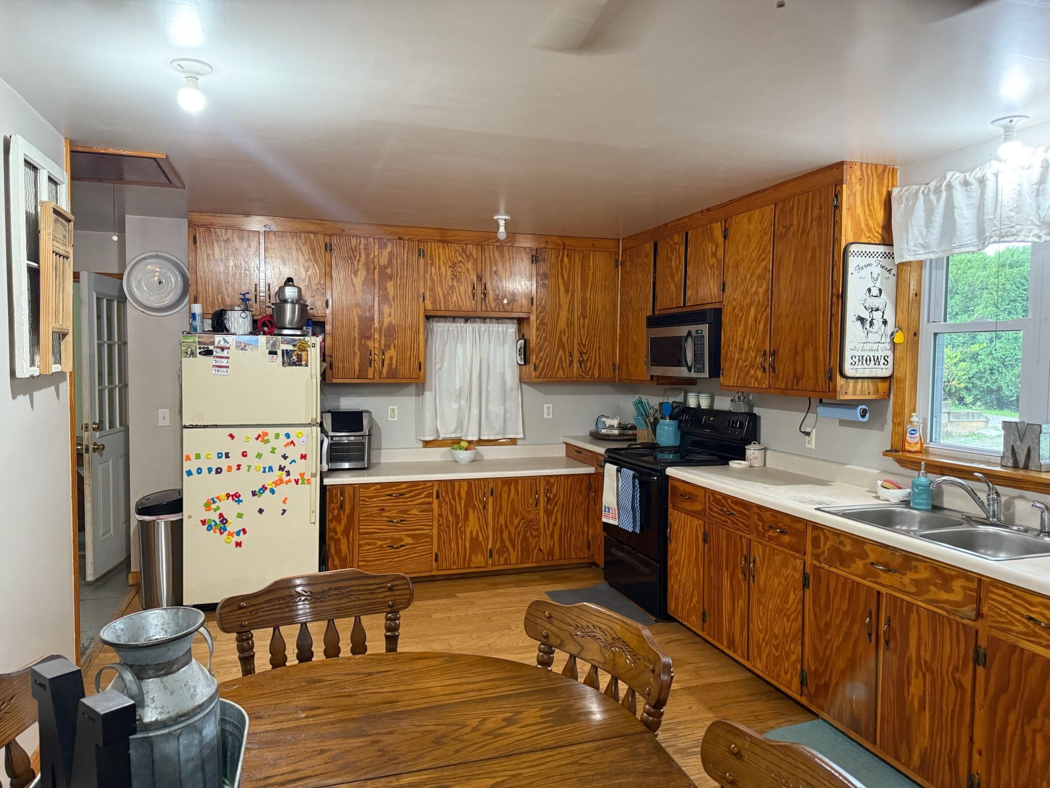 2975 Bethlehem Church Road Mount Hermon, KY 42157 - Photo 4 of 72 a large kitchen with stainless steel appliances a stove a refrigerator a sink dishwasher and a dining table with wooden floor