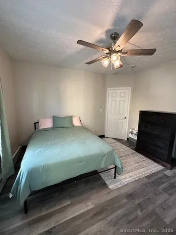 a bedroom with a bed and a ceiling fan