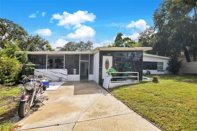 a view of a house with backyard porch and sitting area