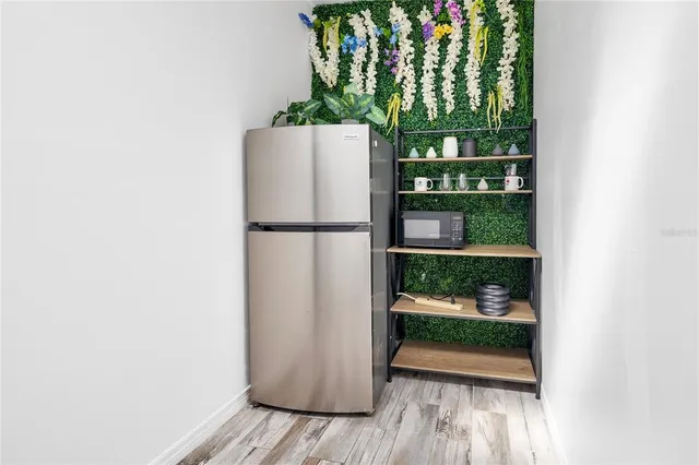 a bedroom with a bed window and a flat screen tv