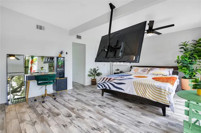 a bedroom with a large bed and a large window