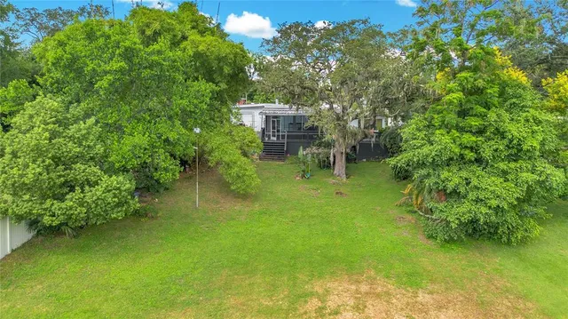 an aerial view of a house with a lake view