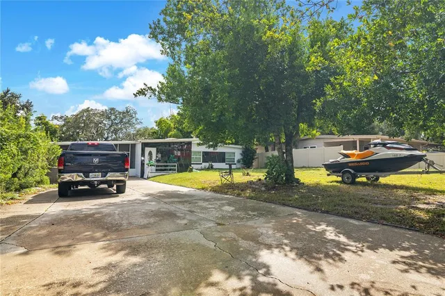 an aerial view of a house with a yard and lake view