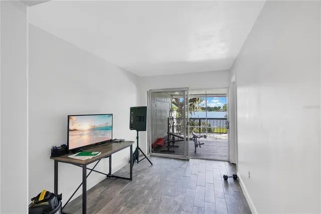 a living room with furniture a window and a flat screen tv