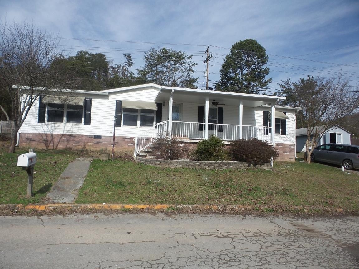 135 King Street Clinton, TN 37716 - Photo 1 of 29 a front view of a house with a yard