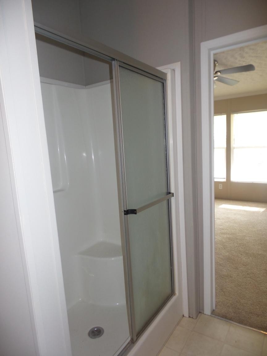 135 King Street Clinton, TN 37716 - Photo 12 of 29 a bathroom with a glass shower door