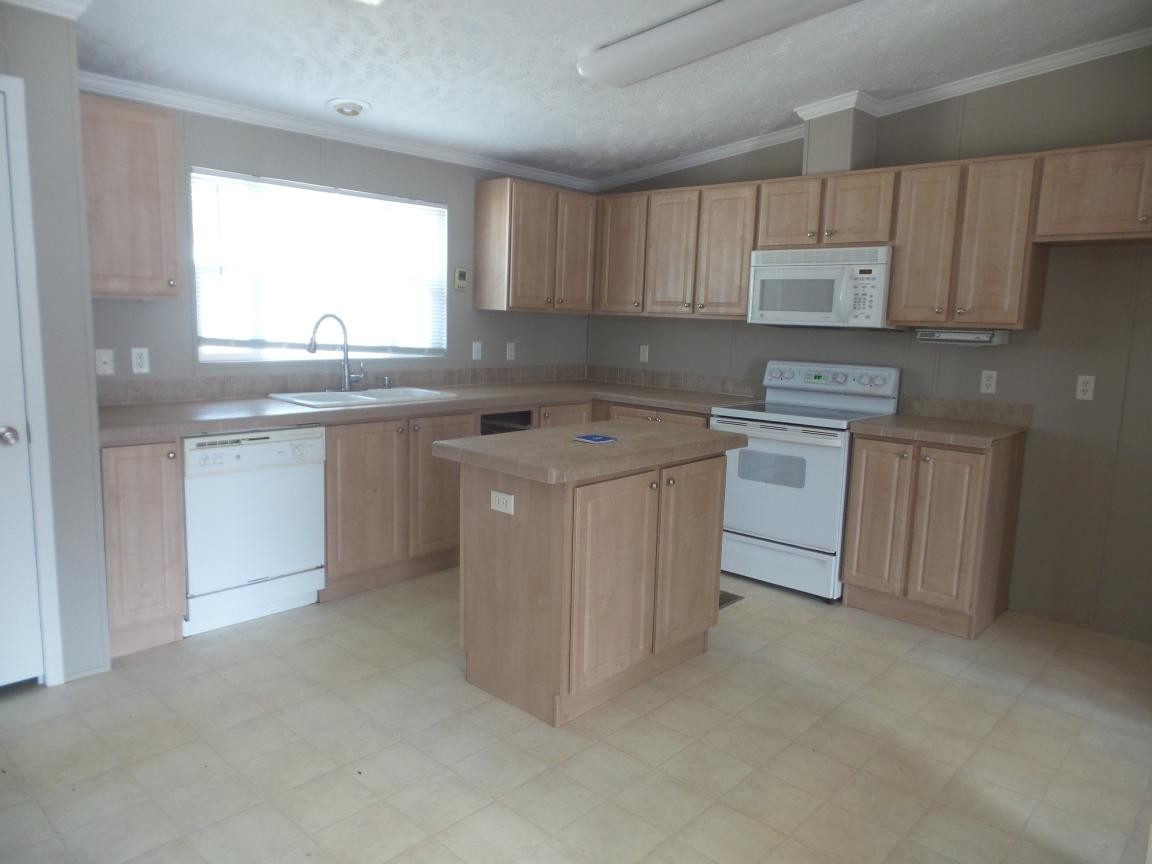 135 King Street Clinton, TN 37716 - Photo 4 of 29 a kitchen with stainless steel appliances granite countertop a stove a sink dishwasher and a refrigerator