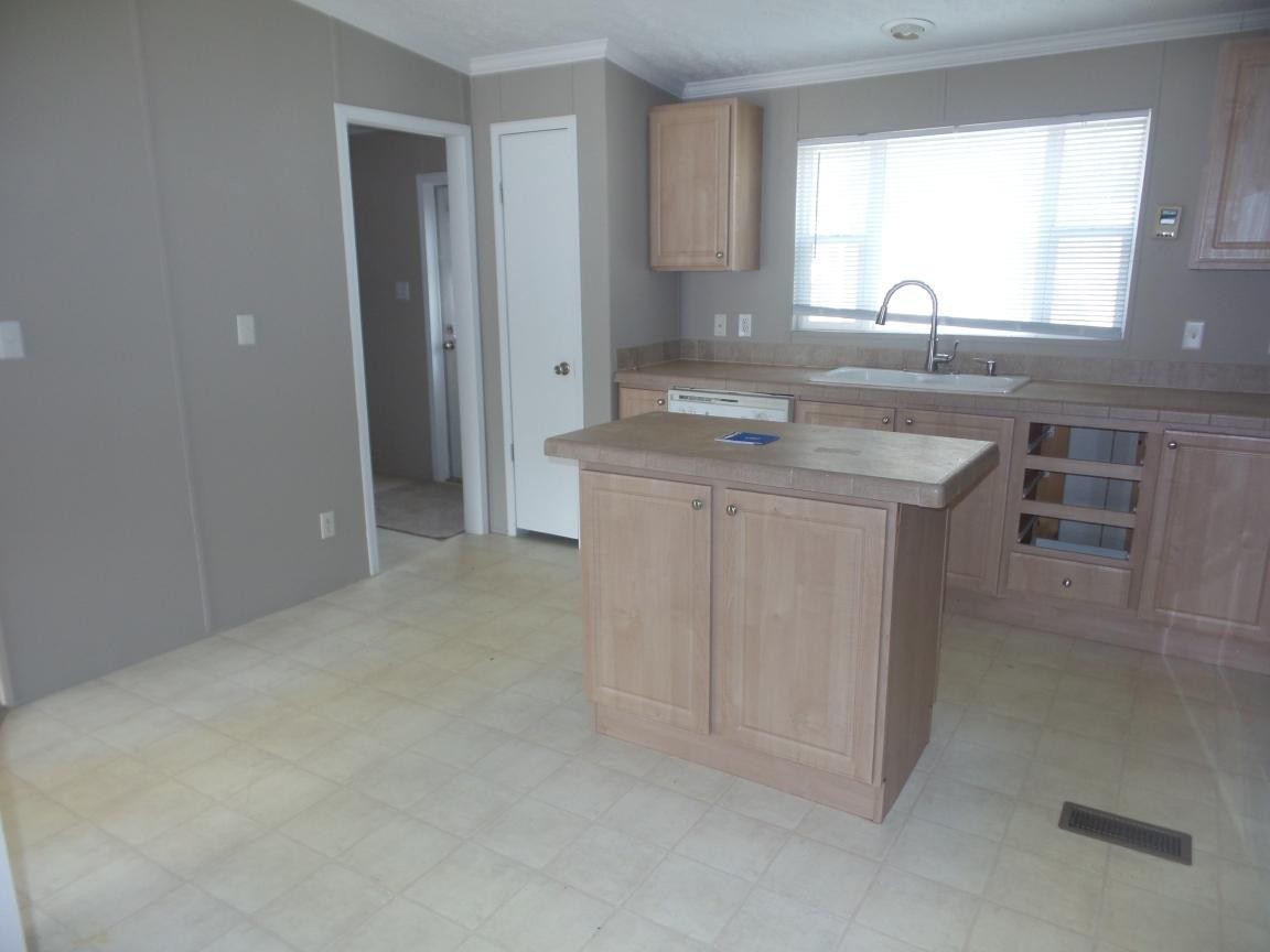 135 King Street Clinton, TN 37716 - Photo 6 of 29 a kitchen with kitchen island sink stove and cabinets
