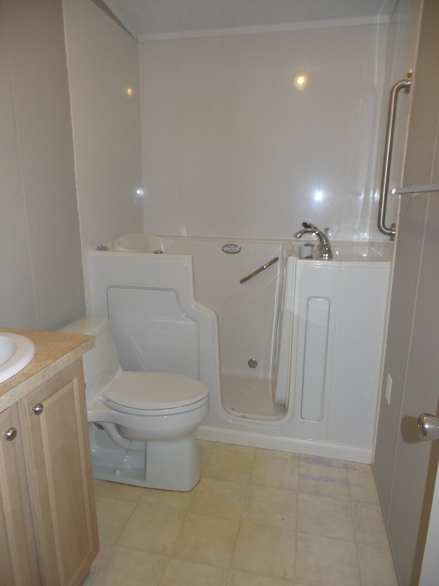 135 King Street Clinton, TN 37716 - Photo 7 of 29 a white toilet sitting next to a shower
