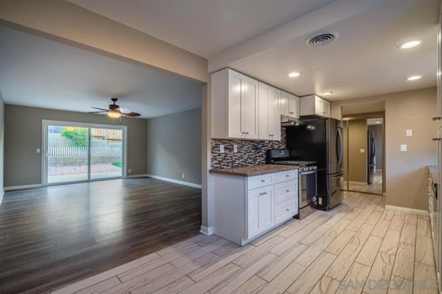 a kitchen with stainless steel appliances a refrigerator sink and cabinets