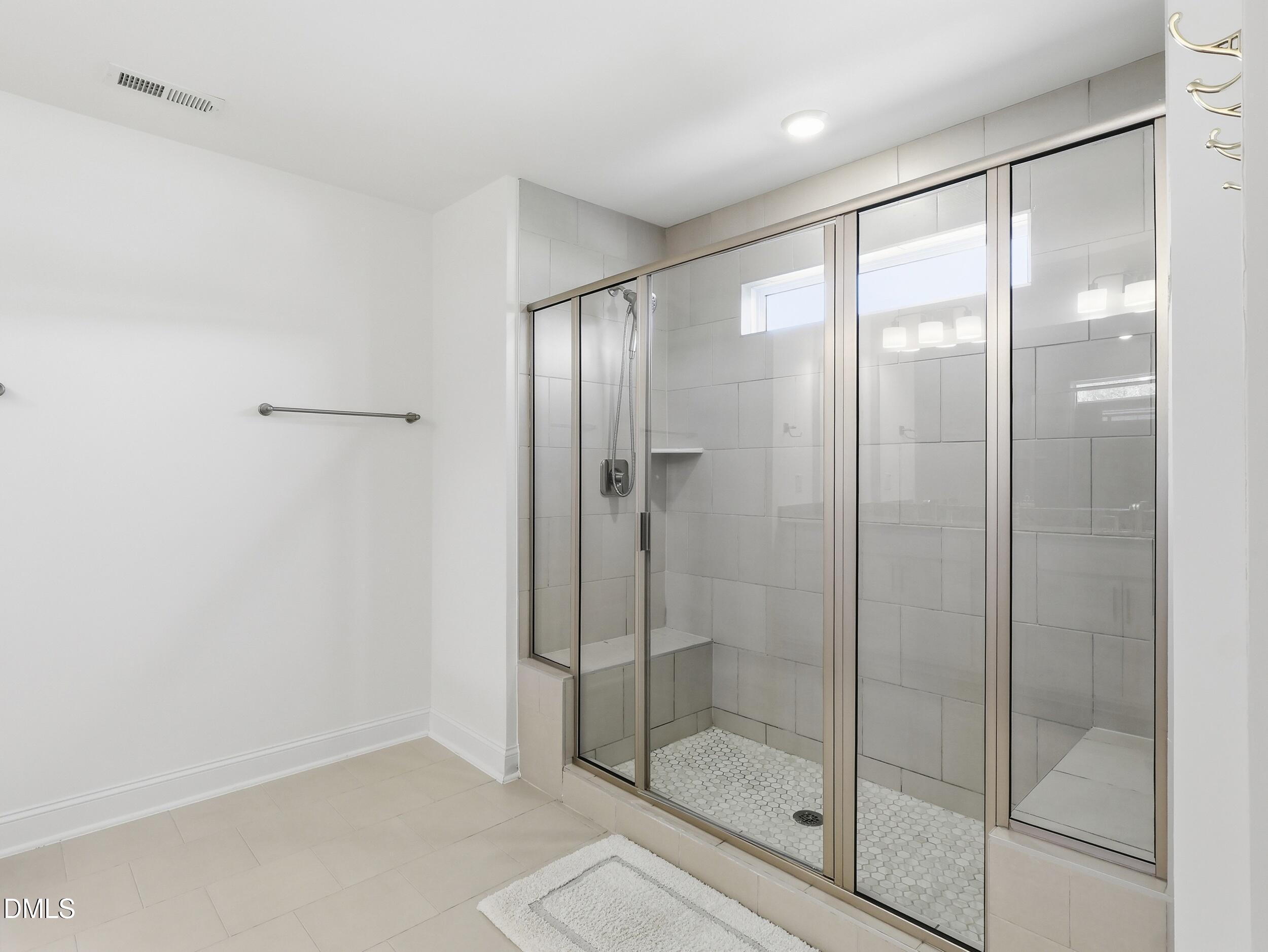 2709 Womble Ridge Drive New Hill, NC 27562 - Photo 34 of 60 a bathroom with a glass shower door