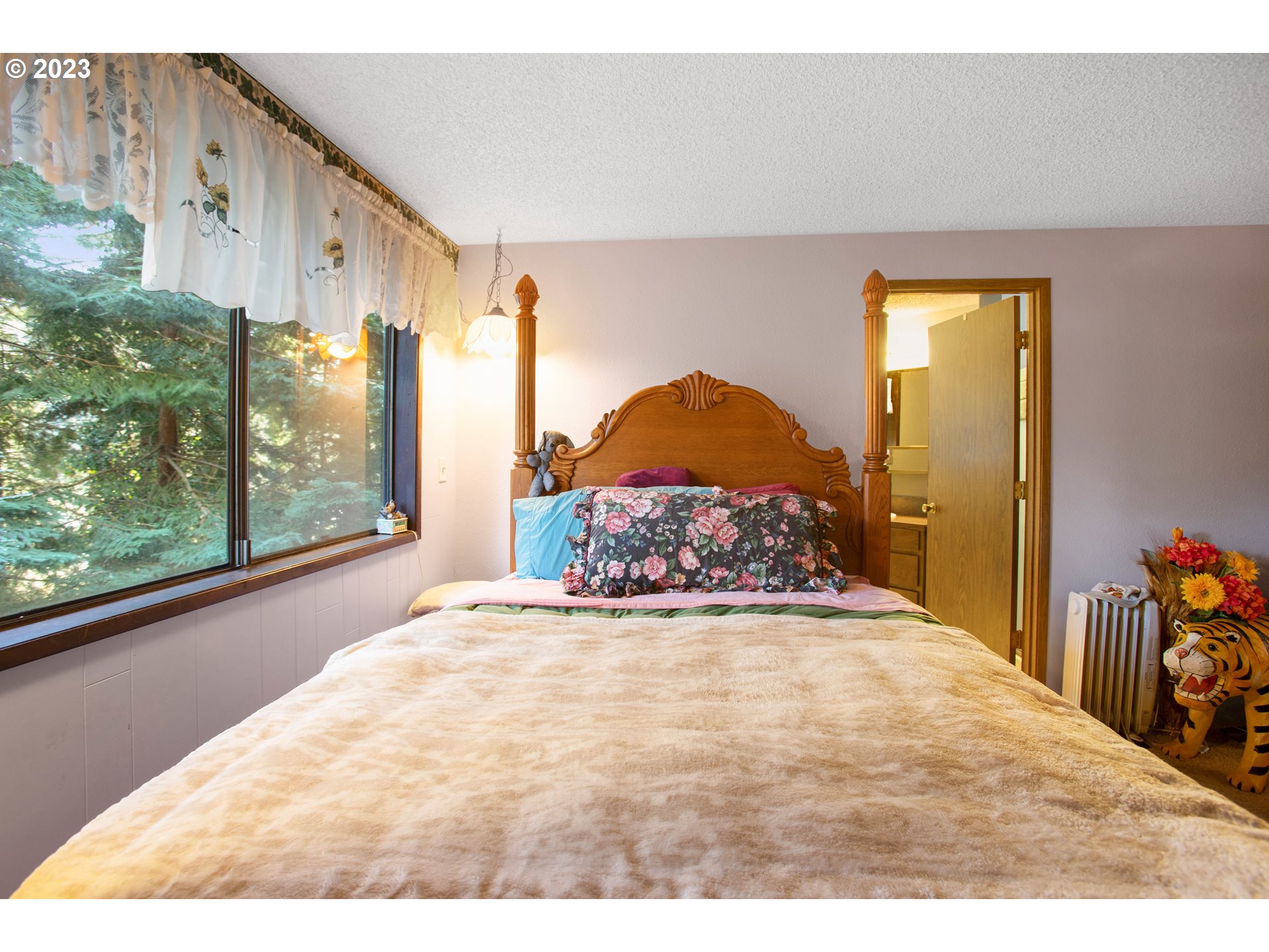 207 Laskey Road Reedsport, OR 97467 - Photo 28 of 48 a large room with a bed and a large window