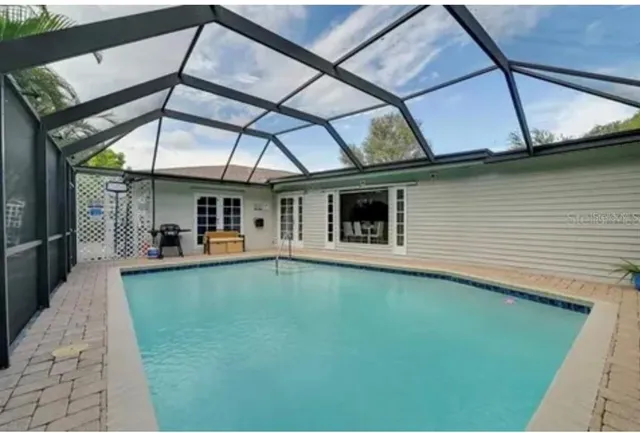 a view of a patio with table and chairs under an umbrella