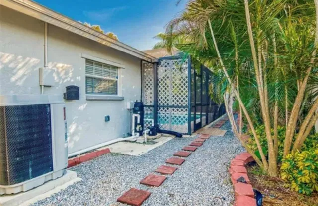 a view of an empty room with window and a kitchen