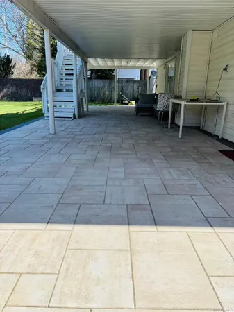 a view of a patio with table and chairs with wooden floor