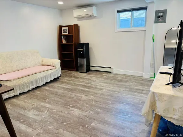 a bedroom with a bed and a flat tv screen on a dresser