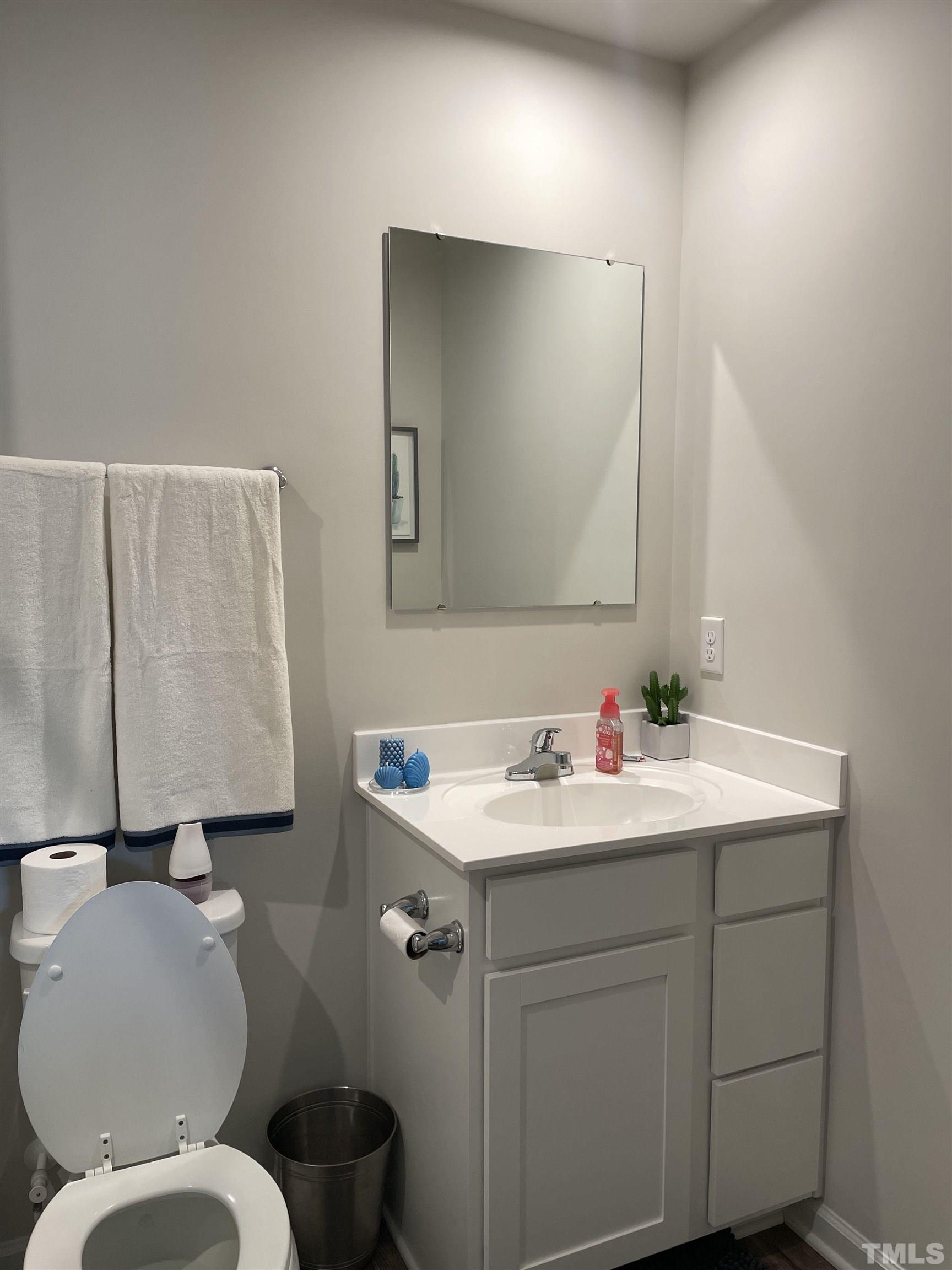 1016 Bent Willow Drive Durham, NC 27704 - Photo 17 of 20 a bathroom with a toilet sink and mirror
