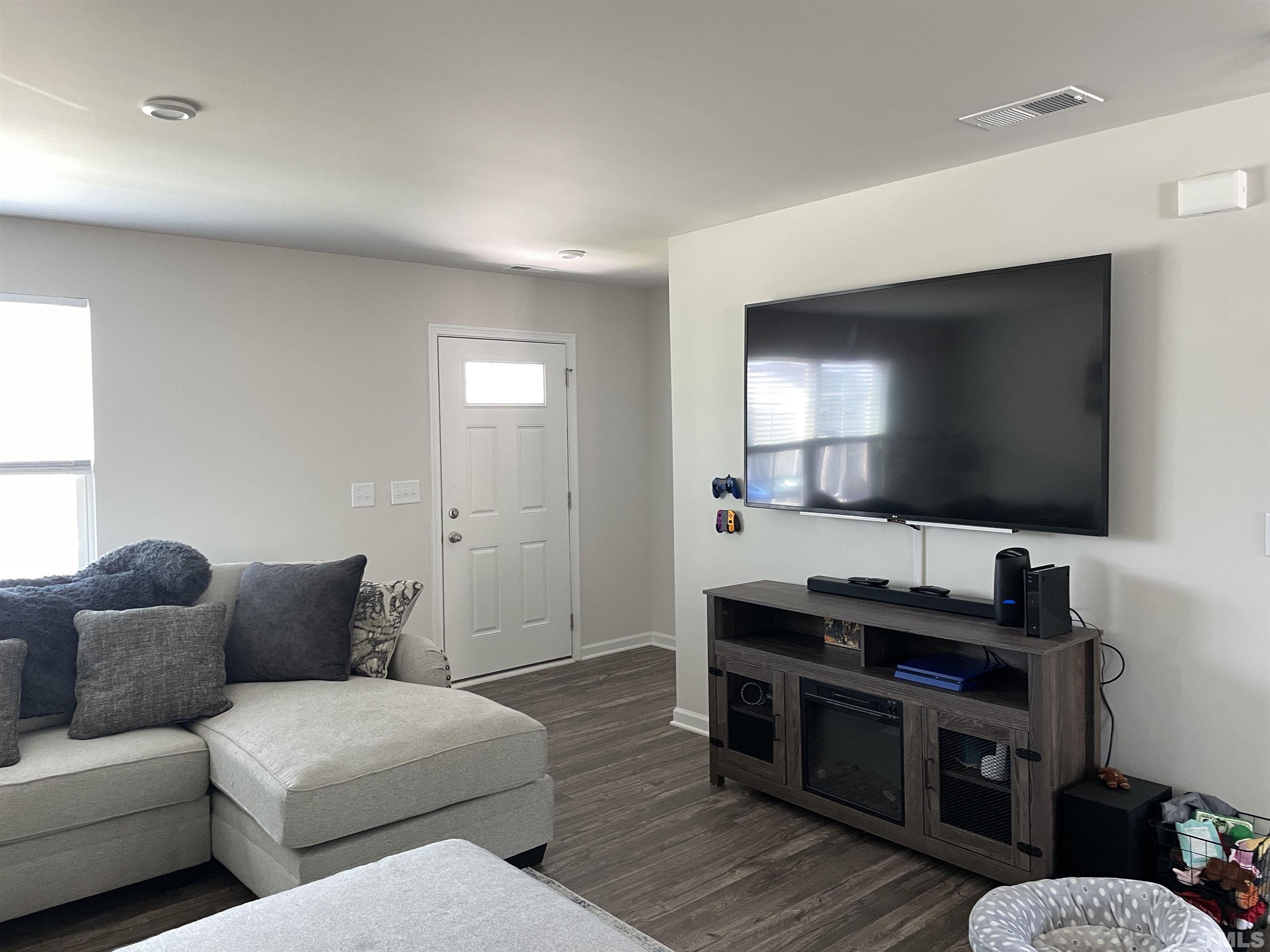 1016 Bent Willow Drive Durham, NC 27704 - Photo 2 of 20 a living room with furniture and a flat screen tv
