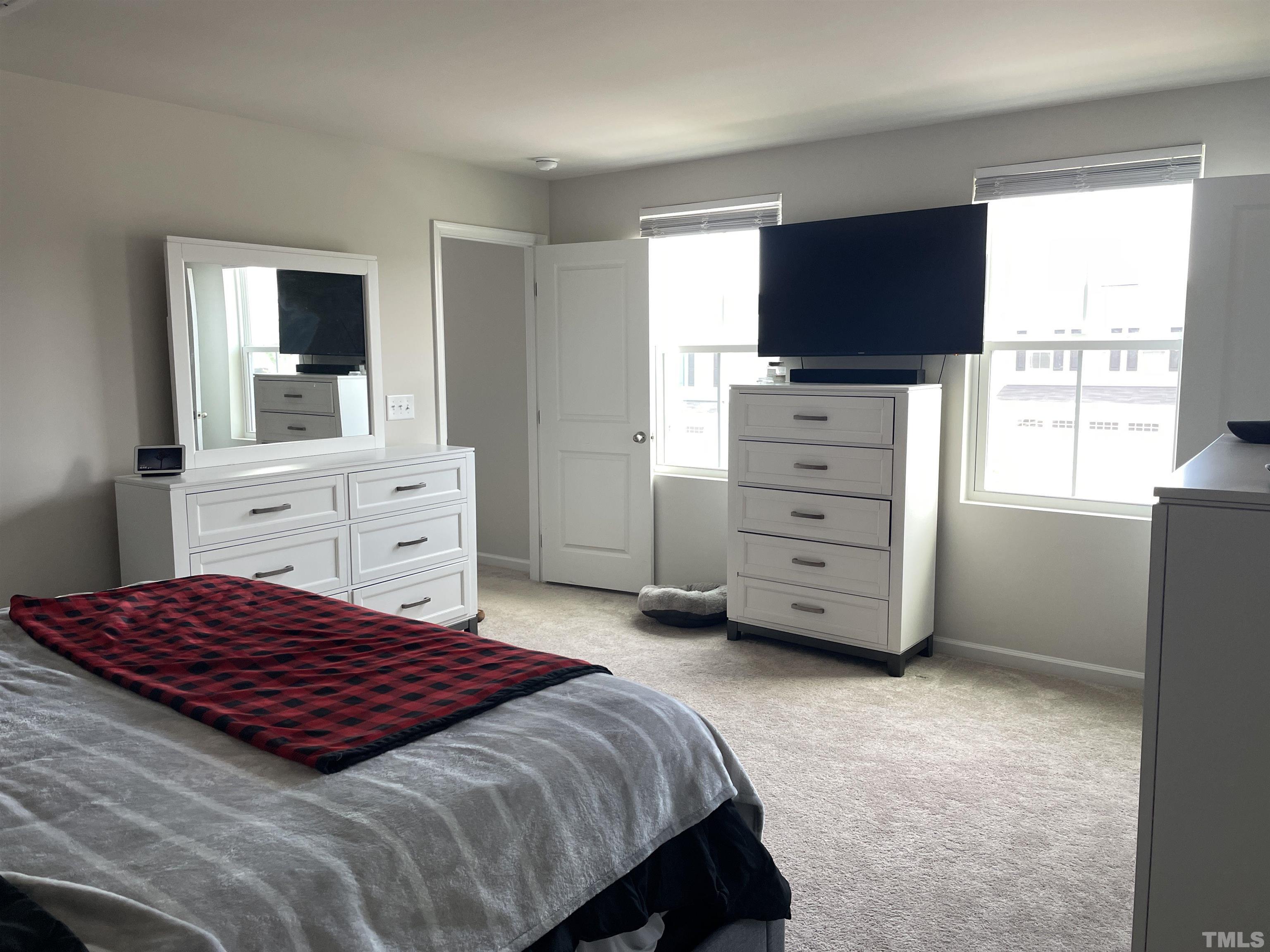 1016 Bent Willow Drive Durham, NC 27704 - Photo 10 of 20 a bedroom with a bed and a flat screen tv
