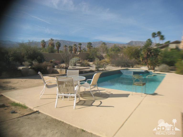 73359 Haystack Road Palm Desert, CA 92260 - Photo 5 of 6 a view of a swimming pool with outdoor seating